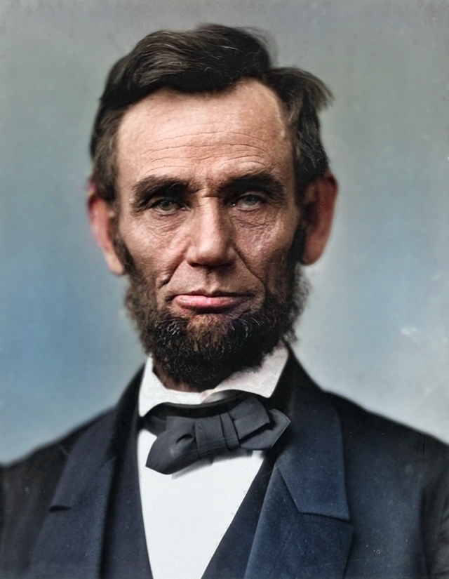 Abraham Lincoln with a serious expression, short dark hair, and a distinctive beard without a mustache. He is wearing a black suit jacket, white shirt, and a bow tie.