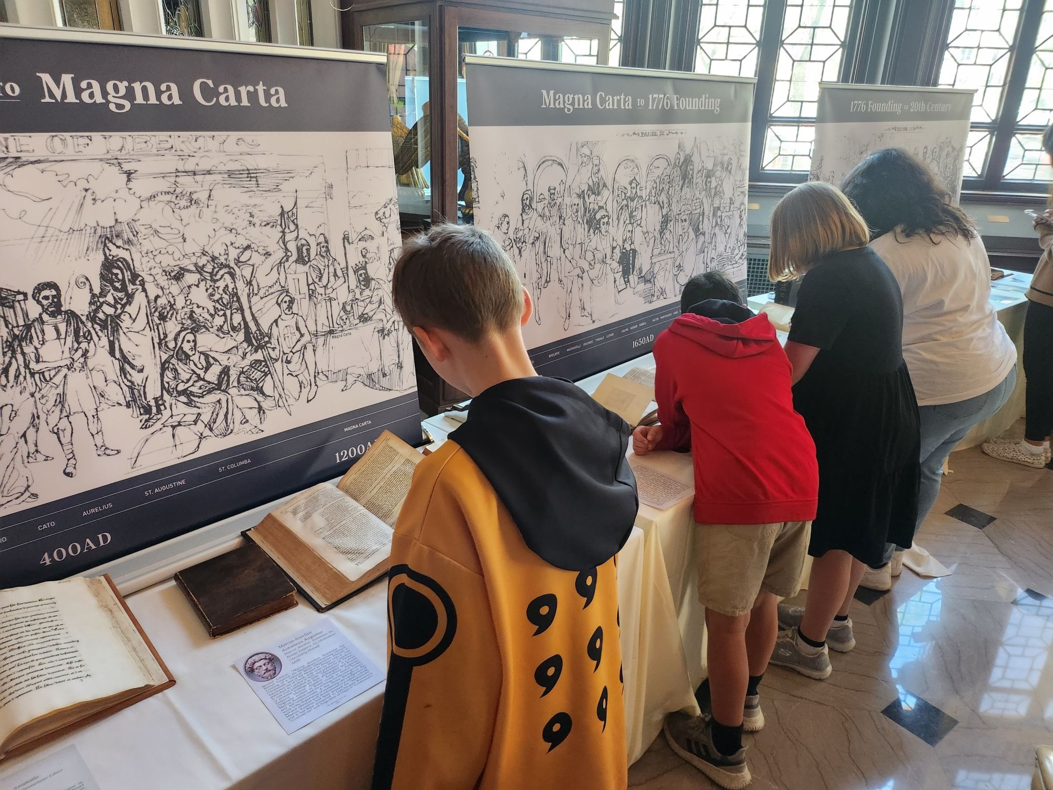 Elementary school students read exhibits on the Magna Carta