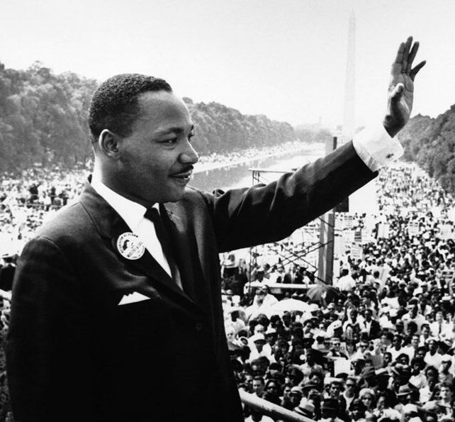 Martin Luther King Jr. waves to a crowd from the steps of the Lincoln Memorial