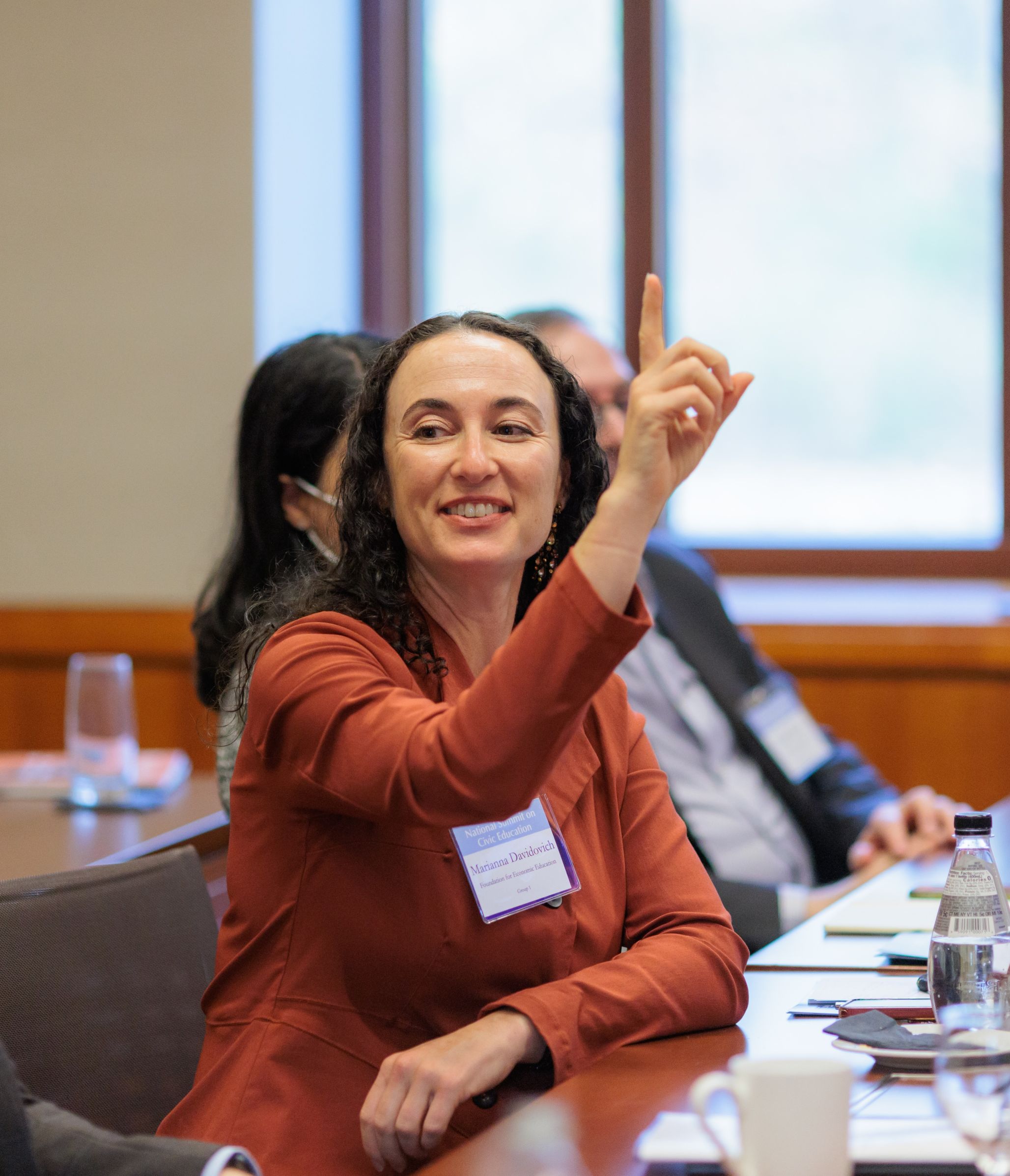 National Summit on Civic Education participant raising her hand