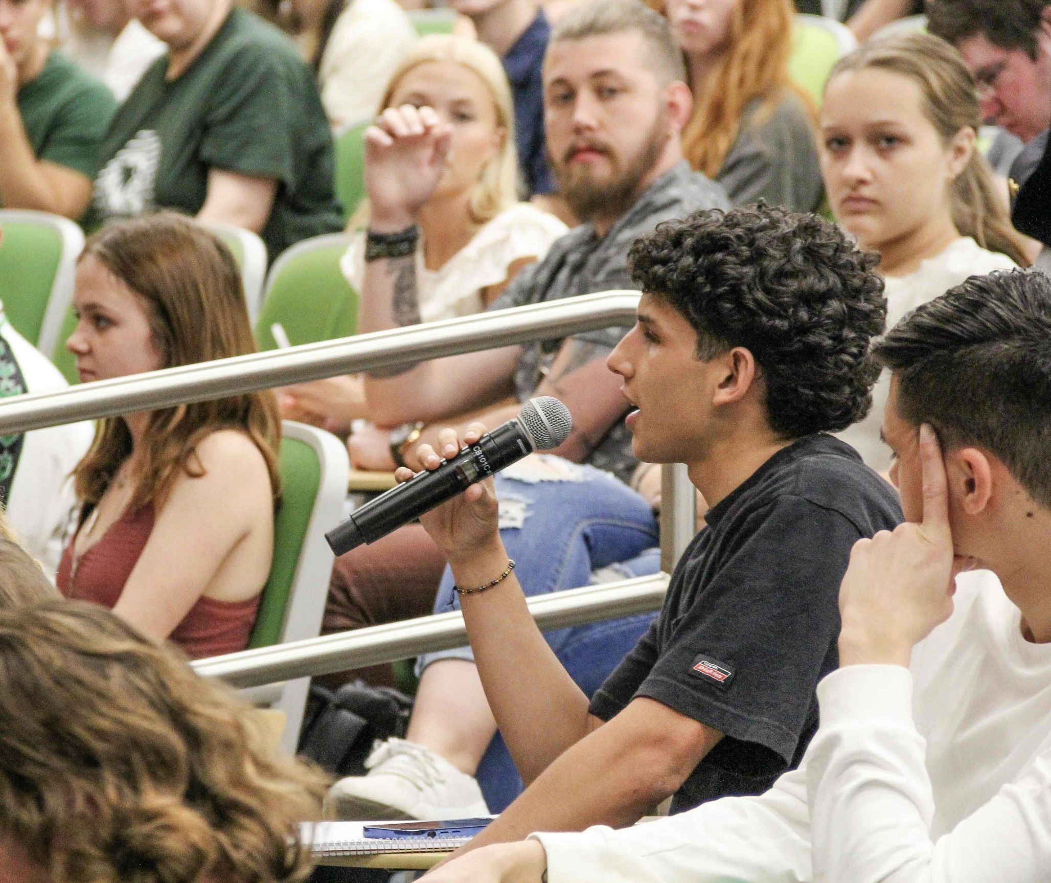 A Utah Valley University student with a microphone asks a question during a JMC-sponsored Constitution Day lecture.