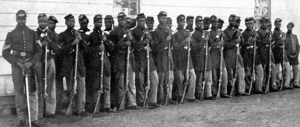 A group of soldiers in military attire holding their weapons