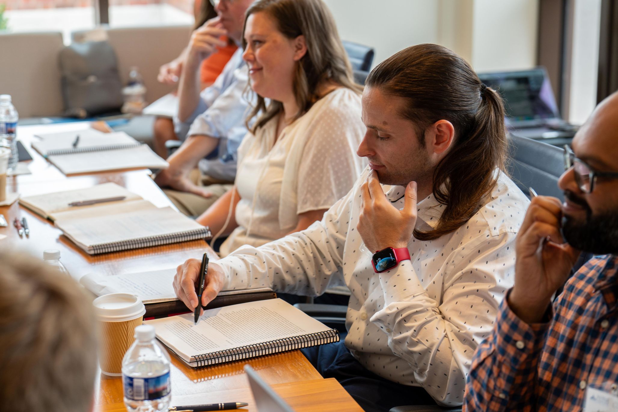 Male K-12 teacher taking notes during teacher professional development