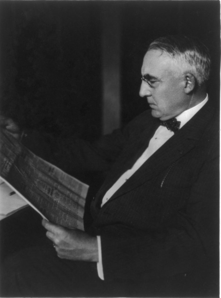 Warren Gamaliel Harding looking at newspaper