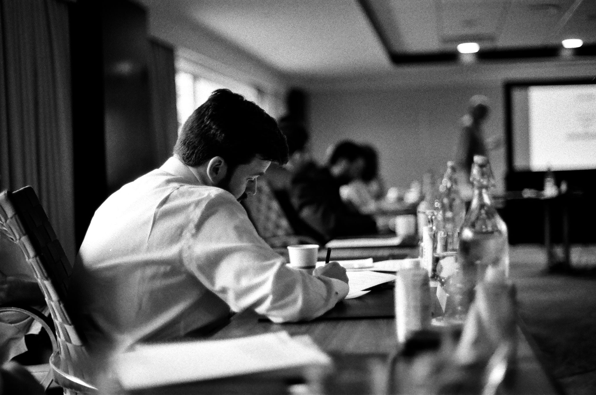 Man writing during a session at the JMC Summer Institute 2024